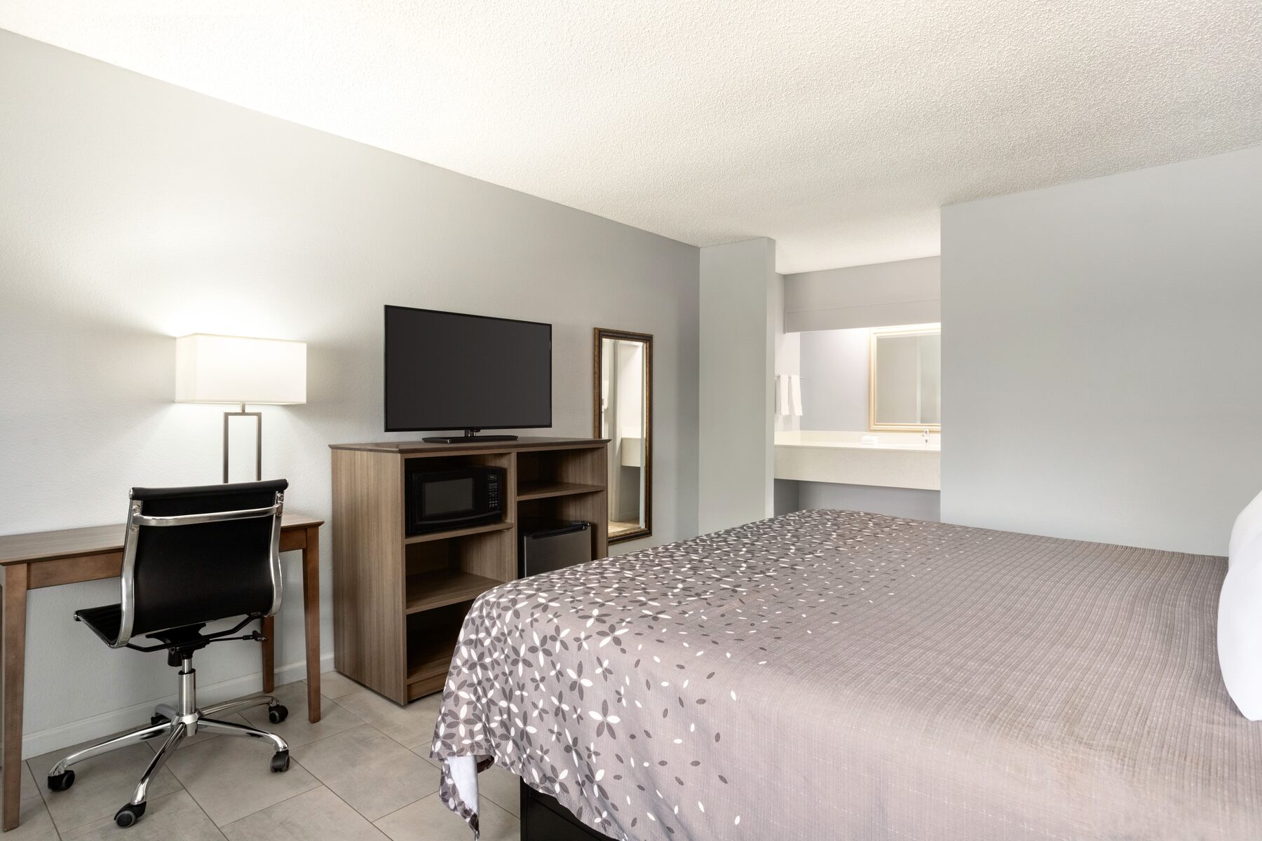 Standard king room with plush bedding at Home Inn and Suites Apopka Florida